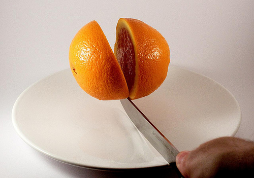 Knife cutting orange